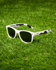 Black and white cow print sunglasses with "Eat Mor Chicken" printed on the inside of arm on sunglasses