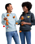 Man wearing Icedream Team Crewneck holding Original Chicken Sandwich String Lights and Woman wearing Waffle Fry Hoodie