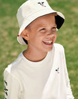 Boy wearing off-white embroidered side of Kids Reversible Cow Print Bucket Hat
