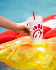 Person placing The Original Chick-fil-A 24oz Insulated Tumbler in cup holder of Waffle Fry Pool Float