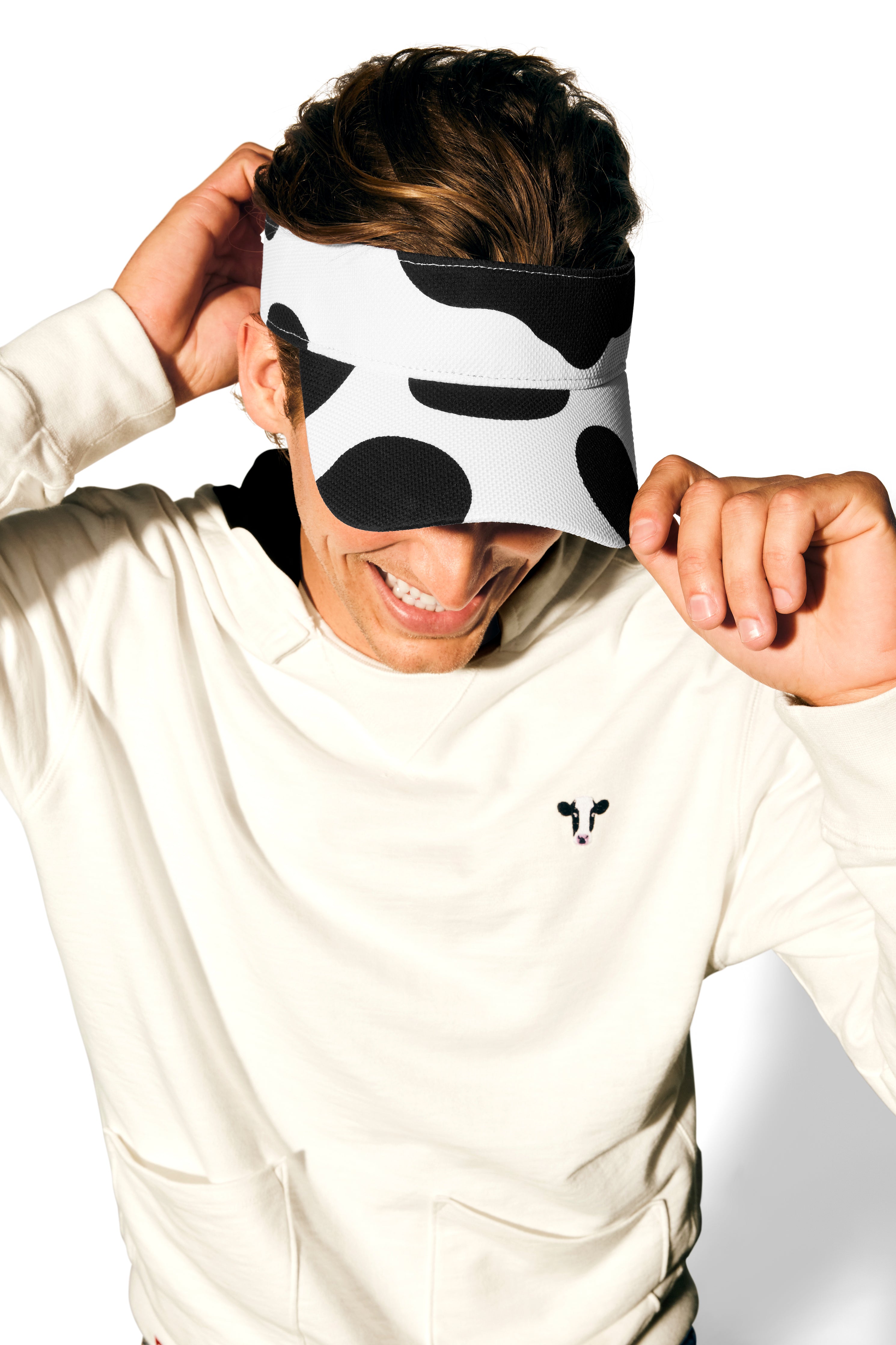 Man wearing Lightweight Cow Pullover hoodie with Adjustable Cow Print Visor.