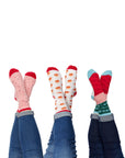 Three pairs of feet in the air wearing the Festive Fun Socks 3-Pack