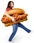 Woman standing holding the Oversized Original Chick-fil-A® Chicken Sandwich Pillow