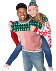 Man wearing a Festive Fun Sweater carrying a woman wearing a Festive Fun Sweater and Festive Fun Pom Beanie