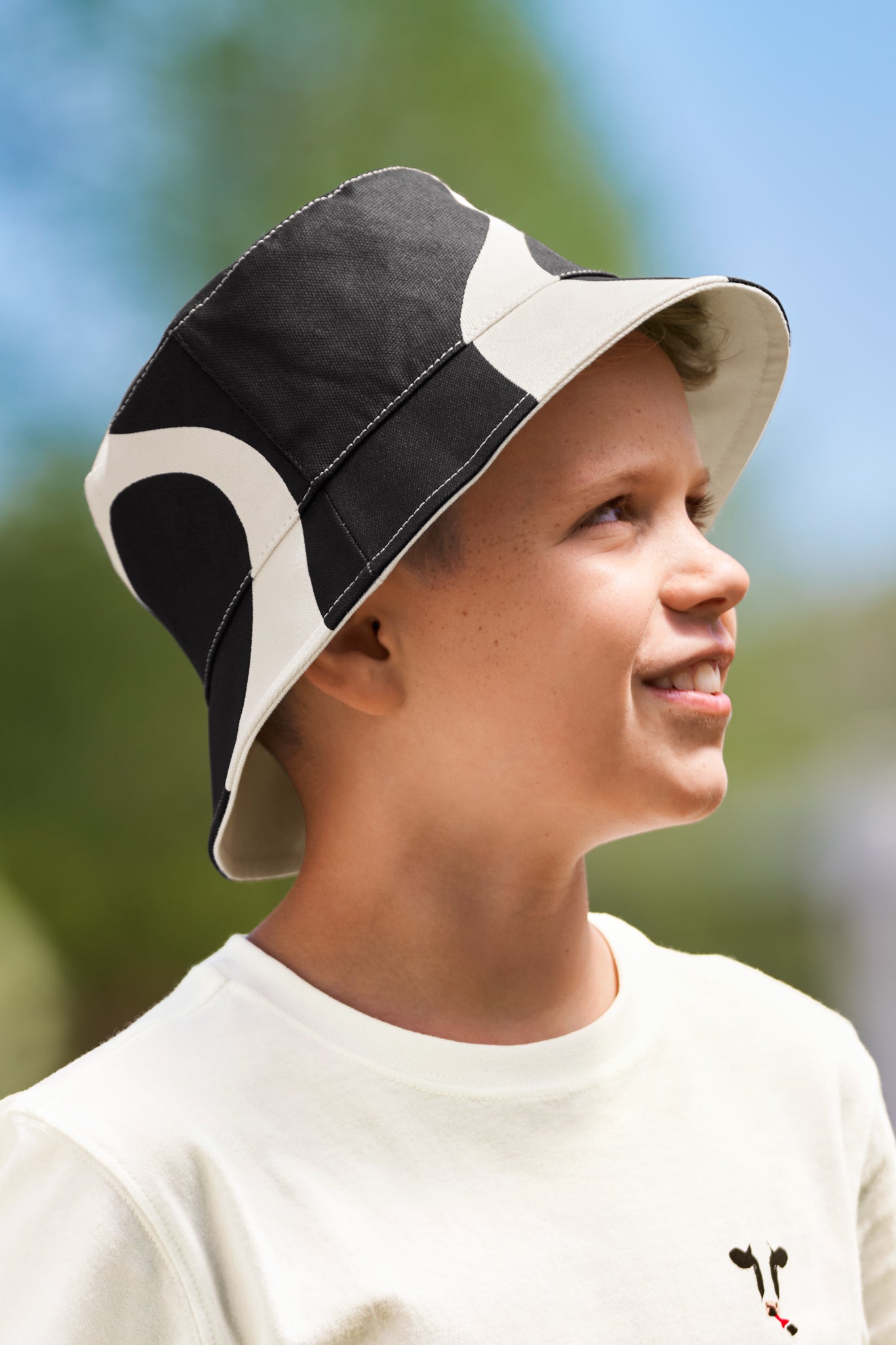 Boy wearing Kids Reversible Cow Print Bucket Hat