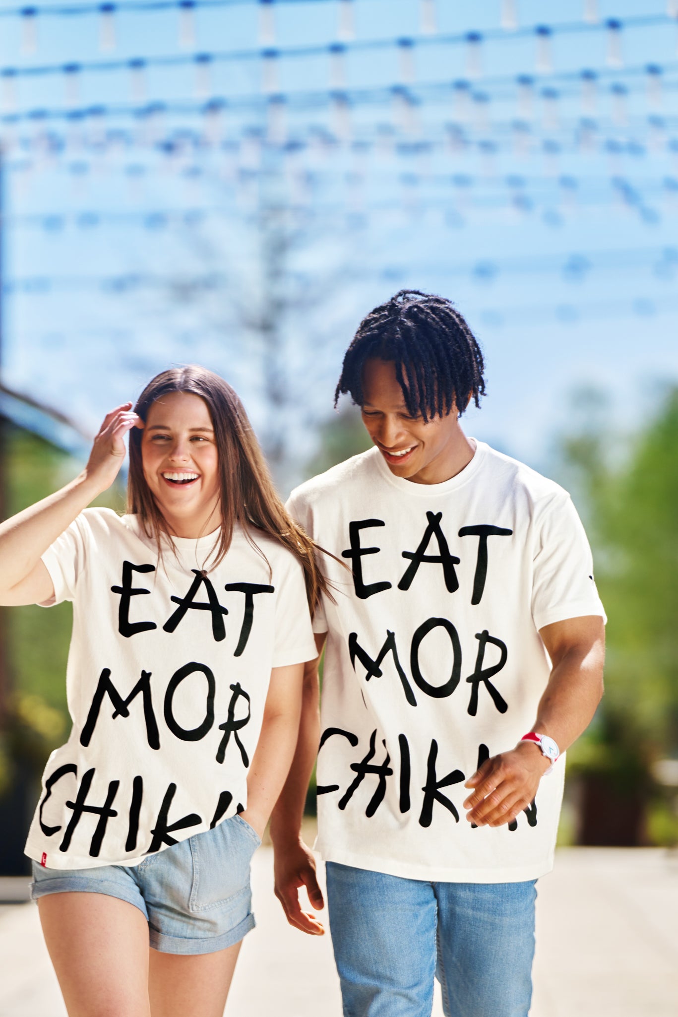 Man and woman wearing Eat Mor Chikin® Graphic Tees