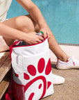 Person placing a bottle in Chick-fil-A Soft Sided Backpack Cooler