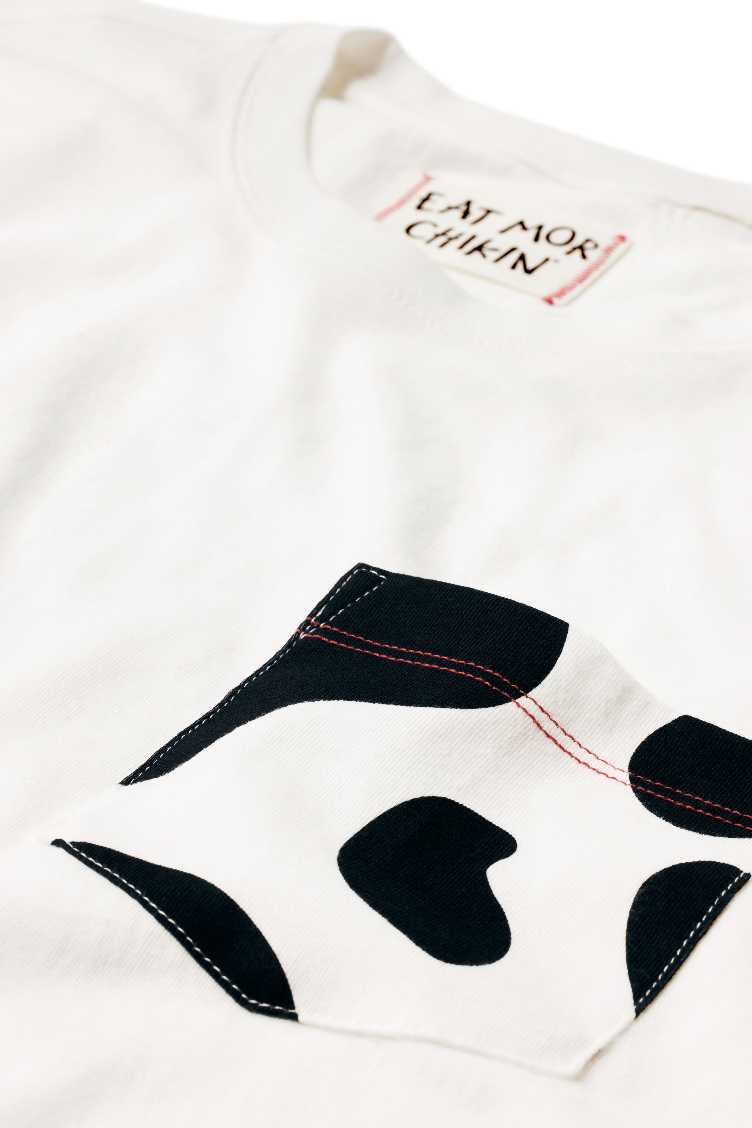 Close up of pocket on black and white Cow Print Pocket Tee