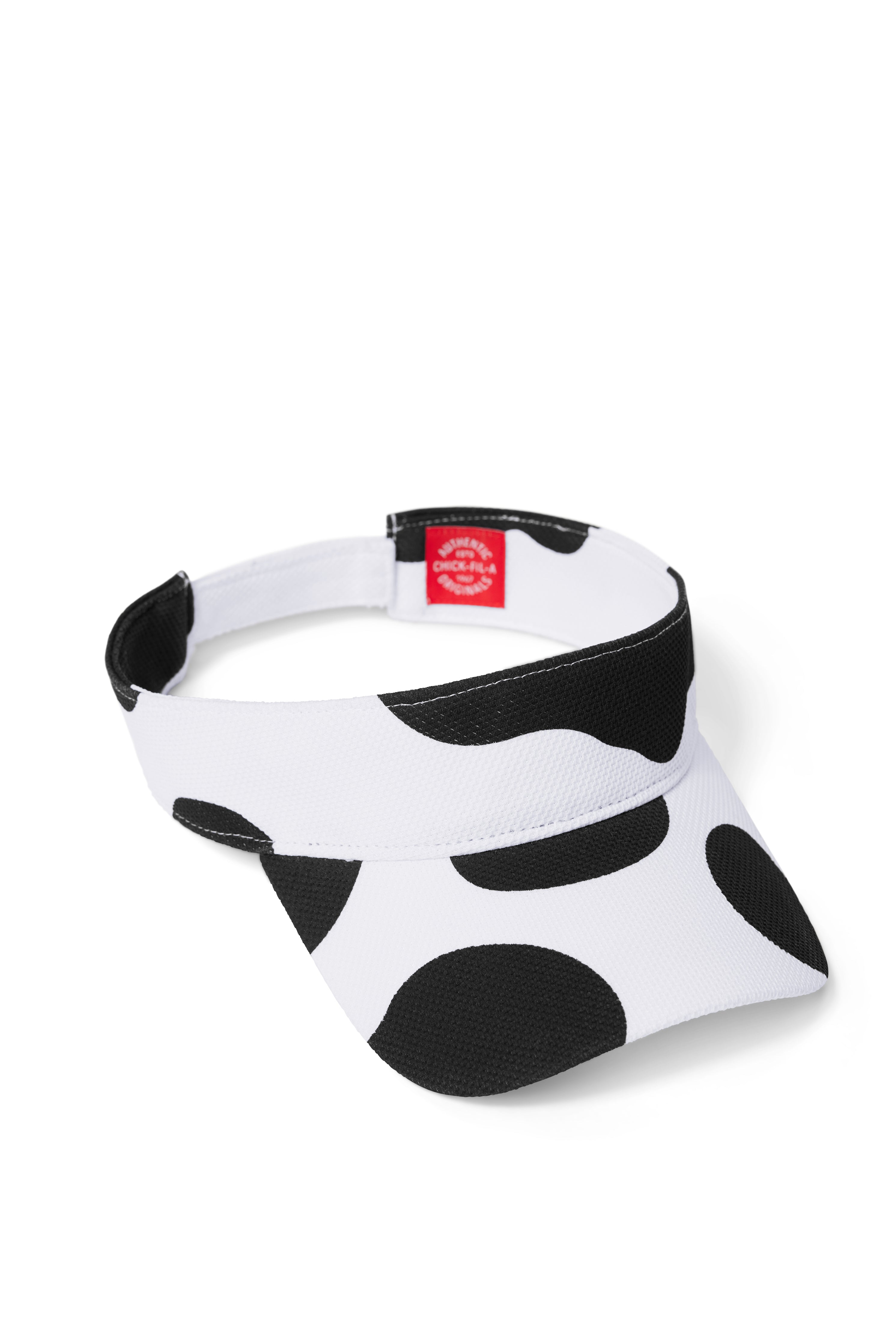 Black and white cow print visor with red interior tag