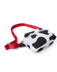 Overhead photograph of black and white Cow Print Belt Bag with red strap