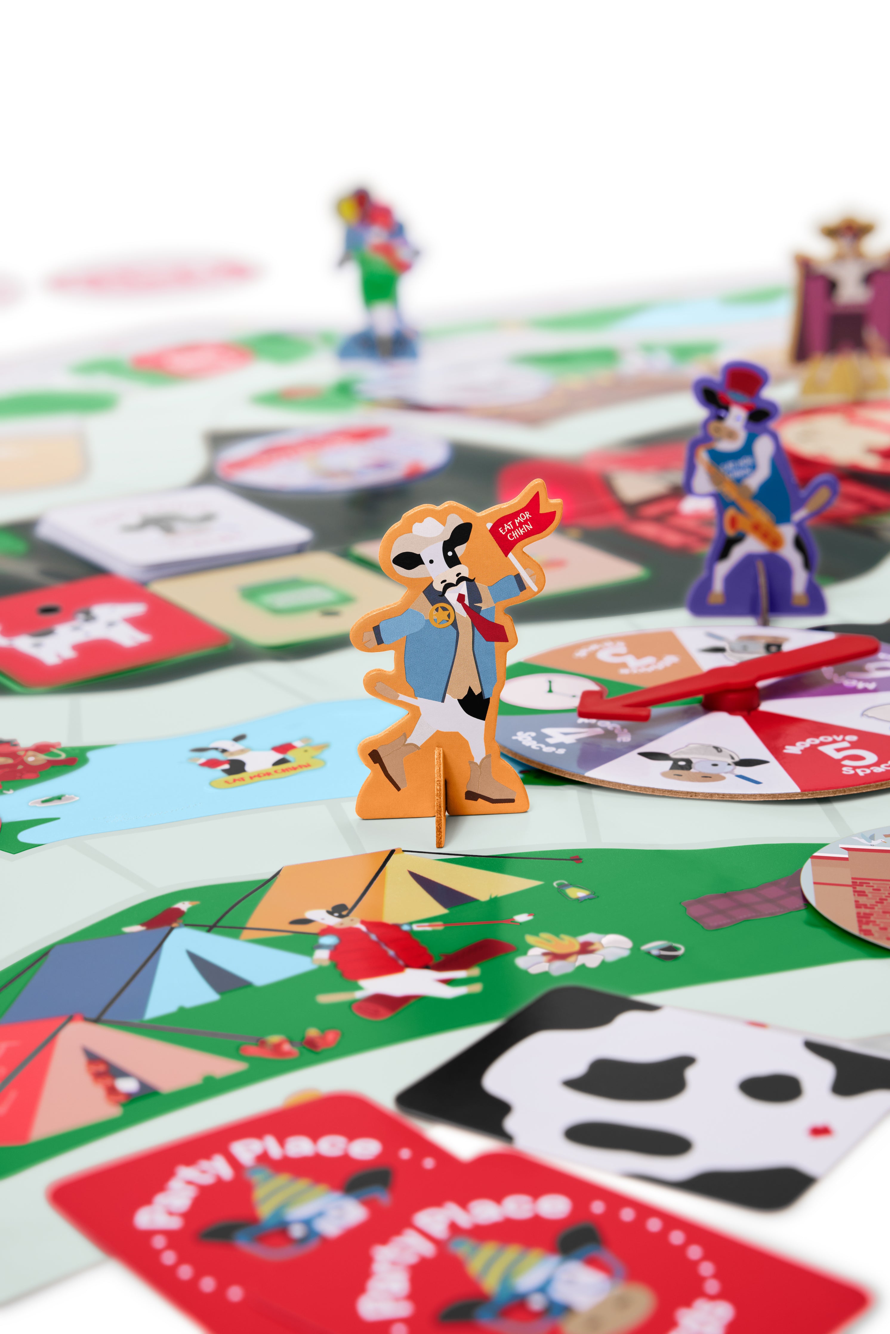 Close up view of Cow Party Game pieces on game board.