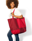 Woman with brunette curly hair wearing red tone-on-tone Reversible Oversized Tote Bag