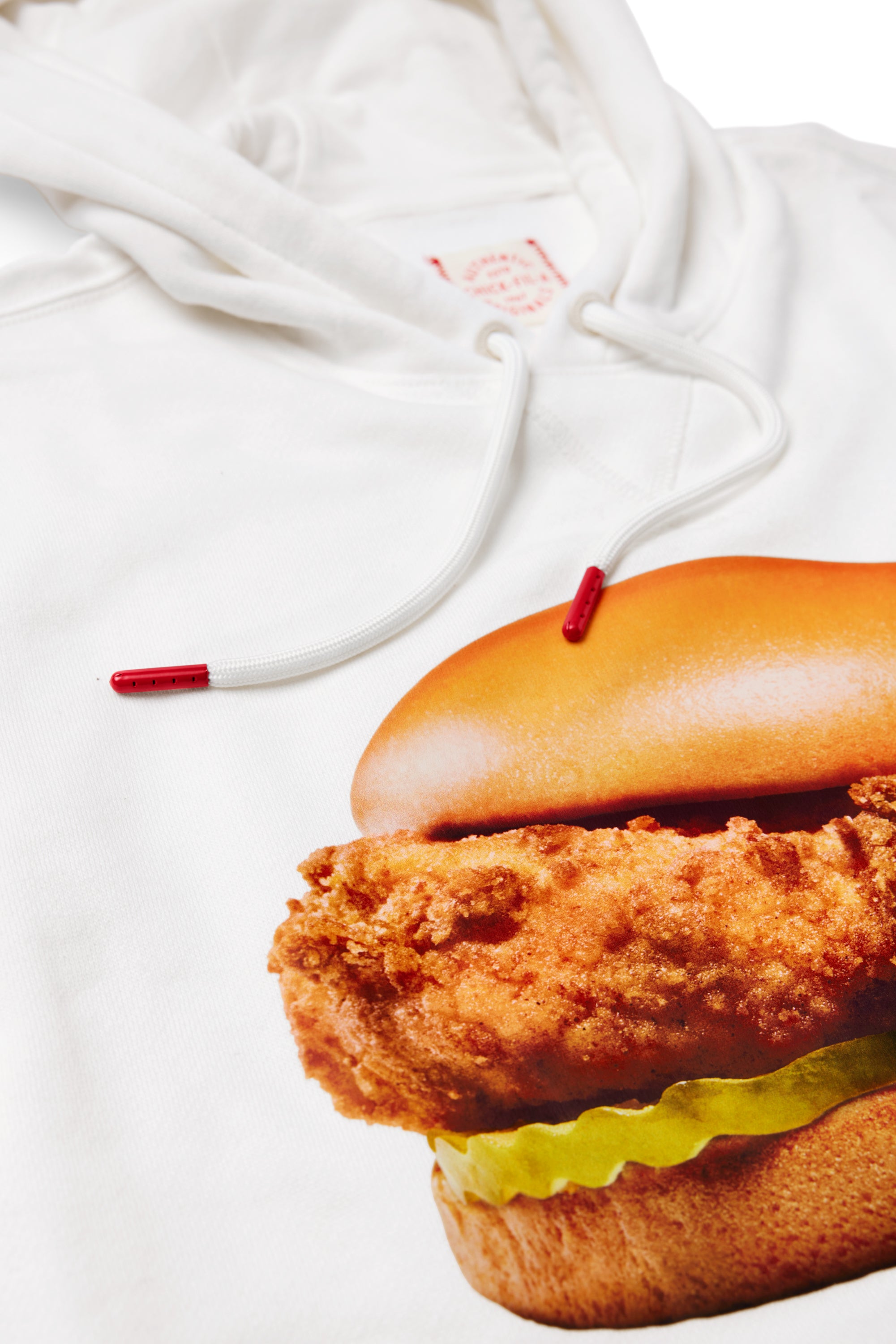 Close up of the red aglets and Chicken Sandwich picture on the Original Chick-fil-A® Chicken Sandwich Print Hoodie