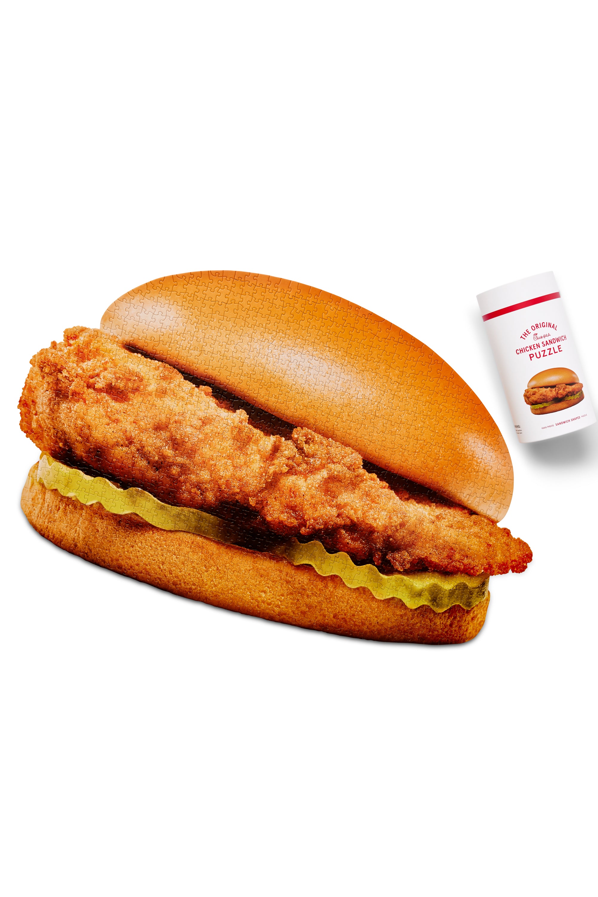 The Original Chick‑fil‑A® Chicken Sandwich Shaped Puzzle Completed with its container next to it
