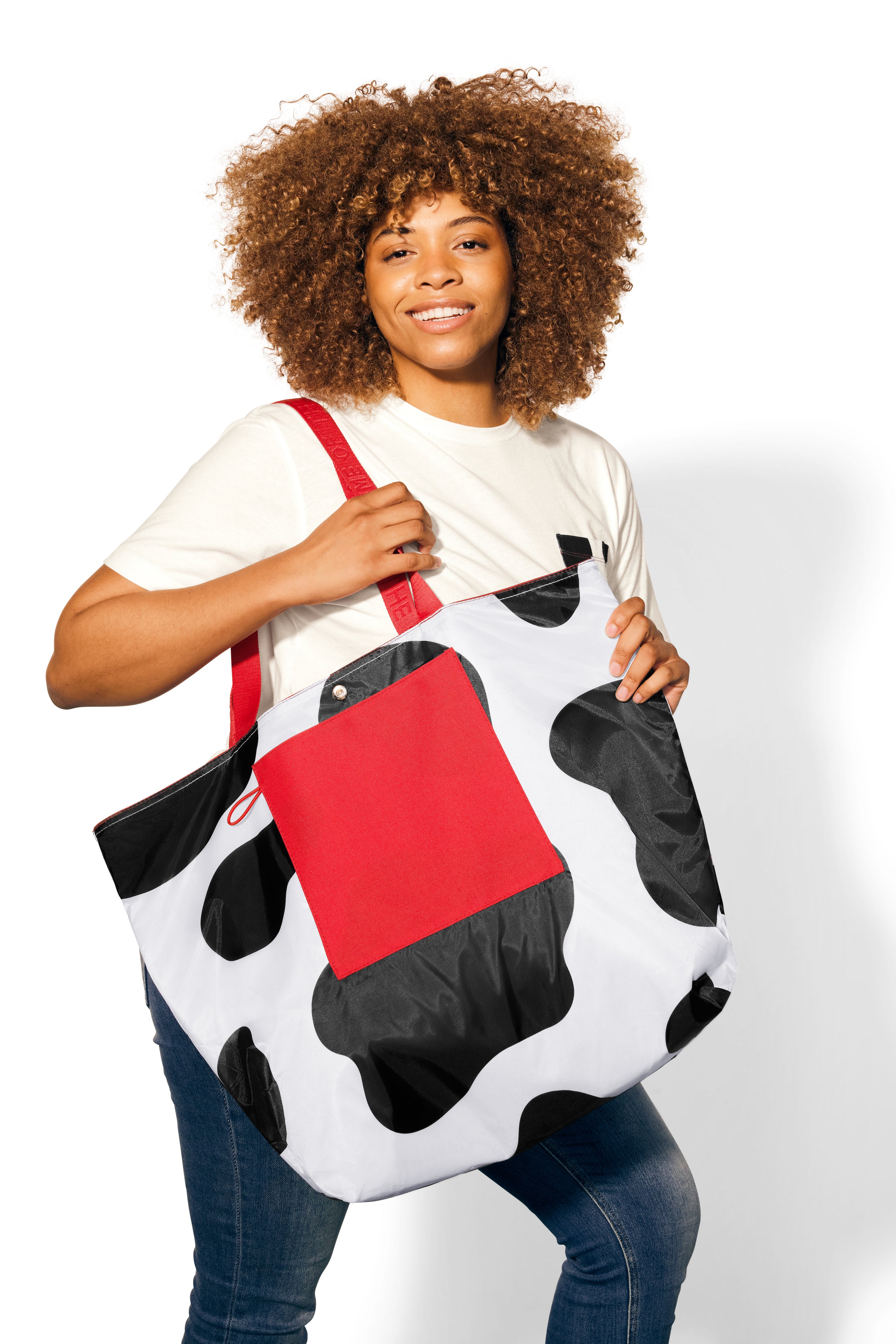 Woman with brunette curly hair wearing cow print Reversible Oversized Tote Bag