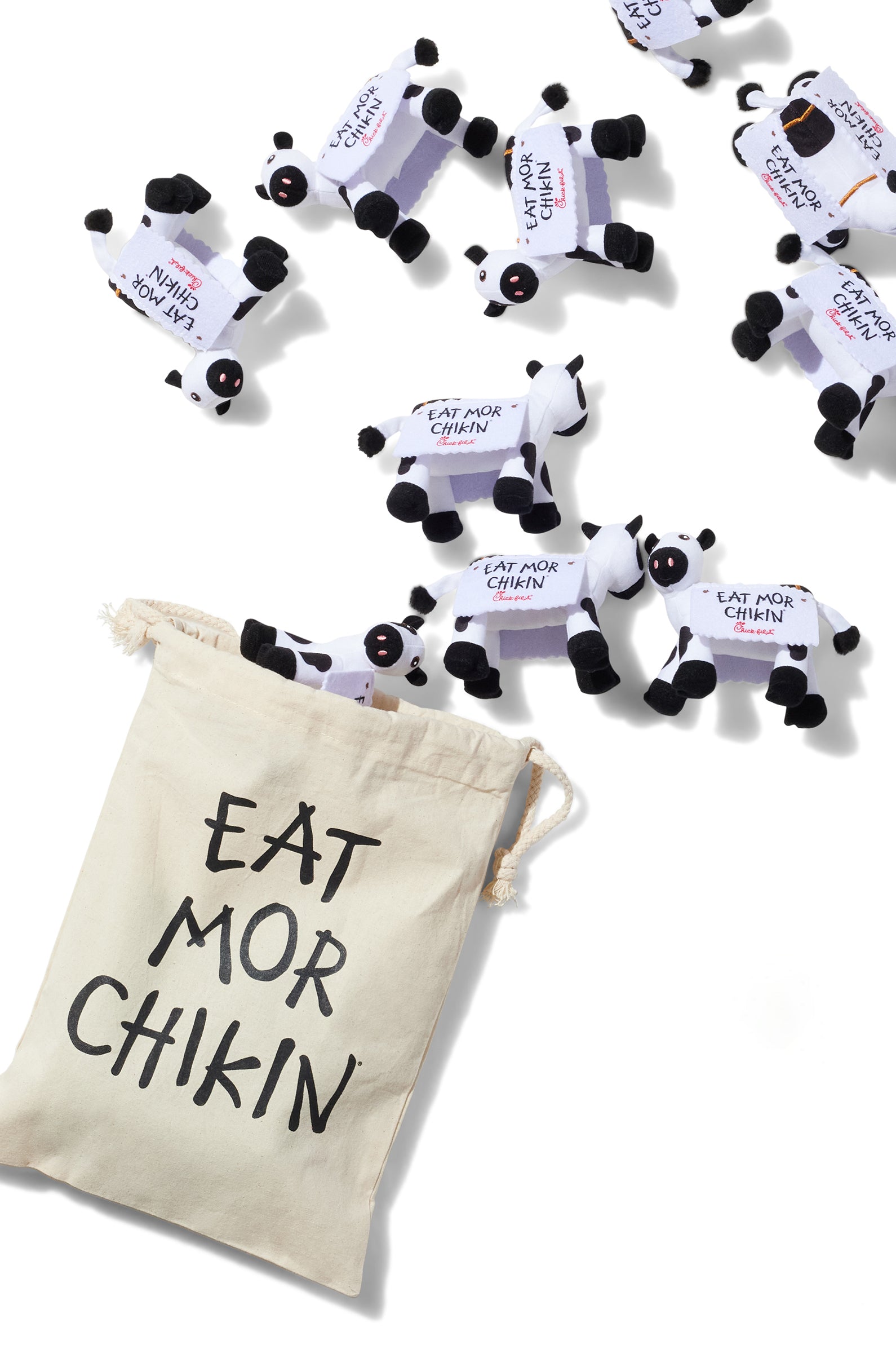 Several mini plush cows with a bag displaying their "Eat Mor Chikin" message from the Shareable Bag of Cows set