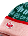  Close-up of silicone Chick-fil-A logo on the cuff of the Festive Fun Pom Beanie