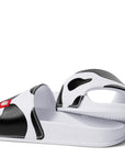 Side view of Slip On Cow Slides showing "Eat Mor Chikin" message on heel of shoe