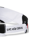 Close up of back of black and white cow print visor with "Eat Mor Chikin" embroidery