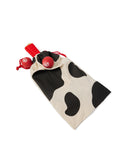 Overhead photograph of Paddle Ball Set in natural canvas and black cow print drawstring bag