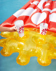 Person placing The Original Chick-fil-A 24oz Insulated Tumbler in Waffle Fry Pool Float cup holders