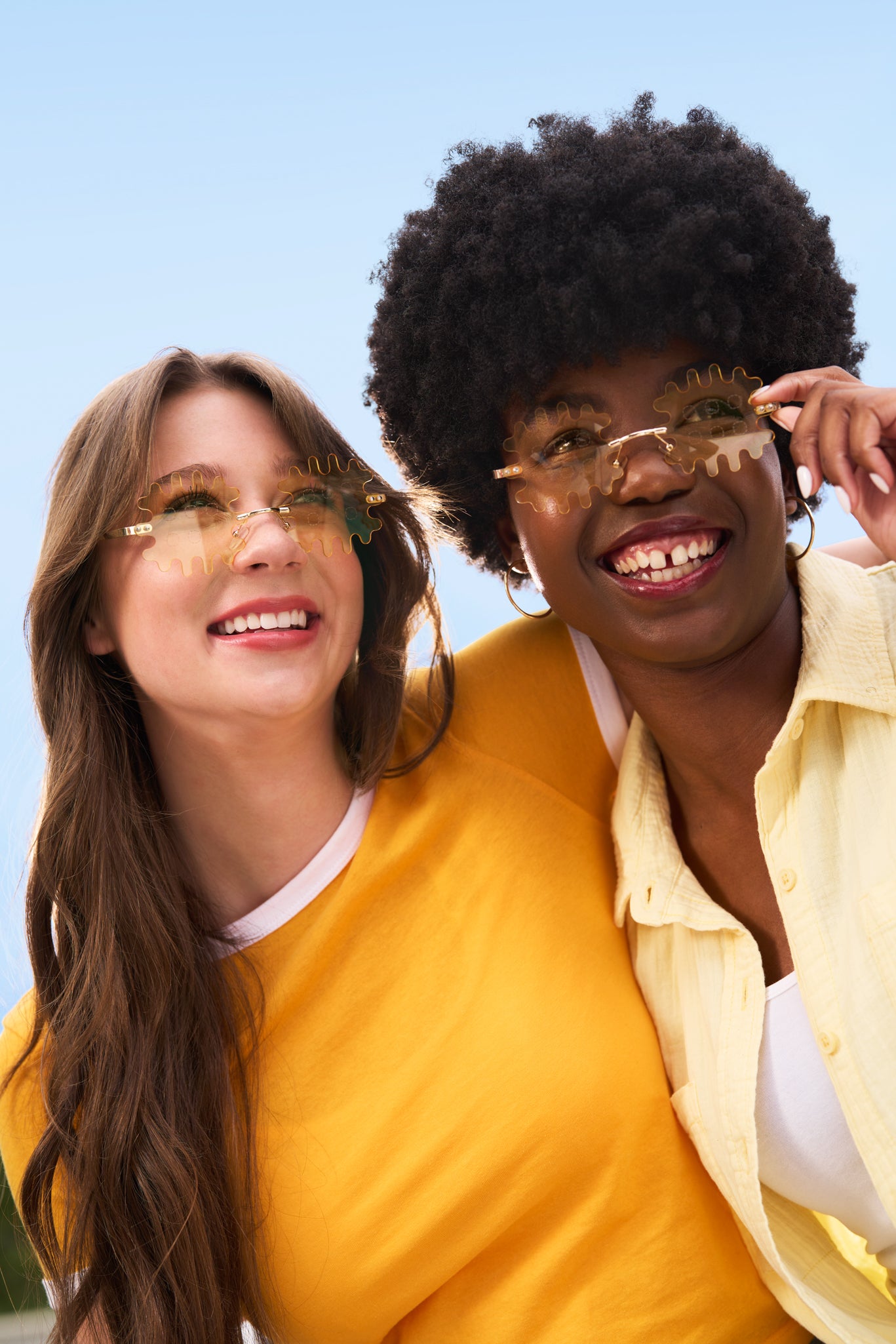 Two women wearing yellow tinted Waffle Fry Novelty Glasses