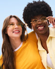 Two women wearing yellow tinted Waffle Fry Novelty Glasses