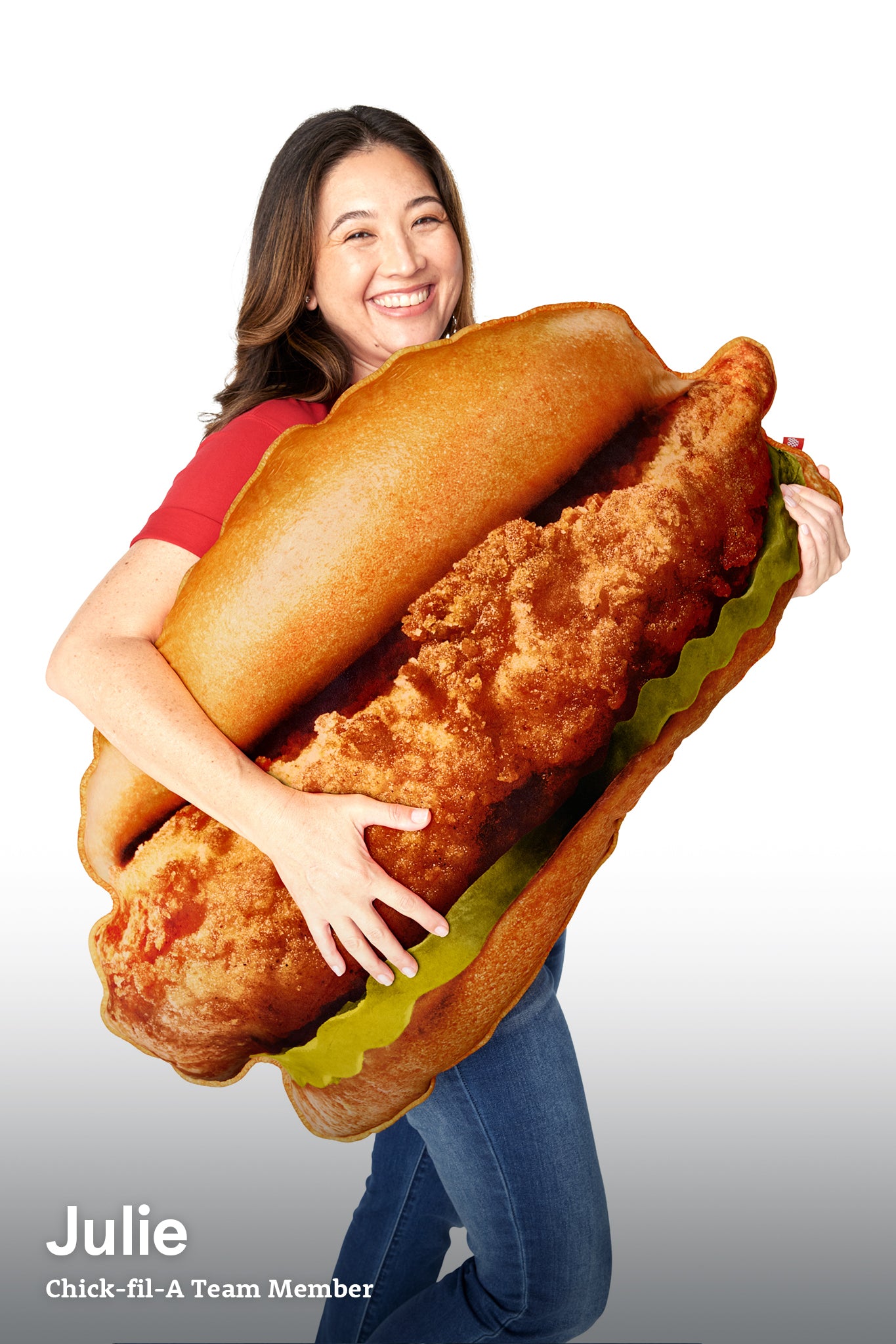 Woman hugging the Oversized Original Chick-fil-A® Chicken Sandwich Pillow
