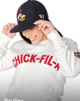 Woman wearing Chick-fil-A Heritage Doodles Wool Hat and Chick-fil-A Heritage Doodles Crewneck looking down