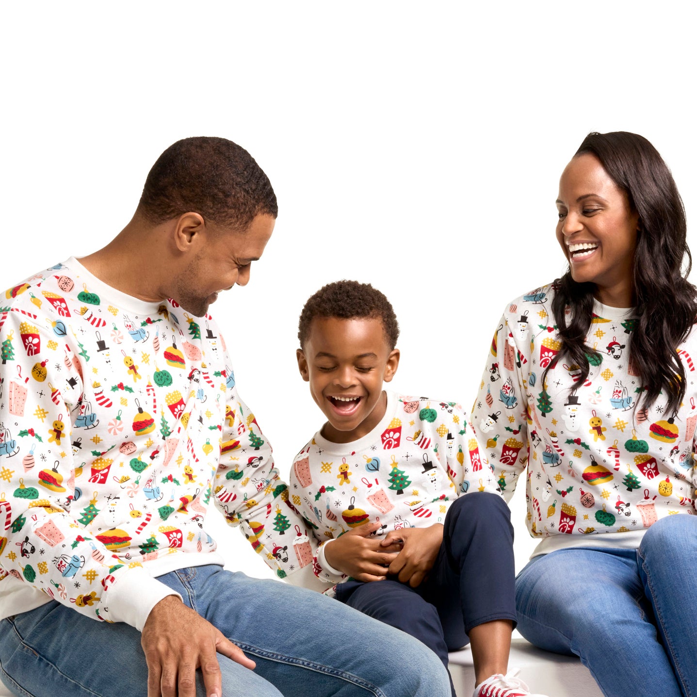 Two adults wearing the Holiday Adult Crewneck and Kid wearing the Holiday Youth Crewneck