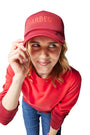 Red/Barbeque Sauce Trucker Hat on woman with blonde hair