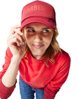 Red/Barbeque Sauce Trucker Hat on woman with blonde hair