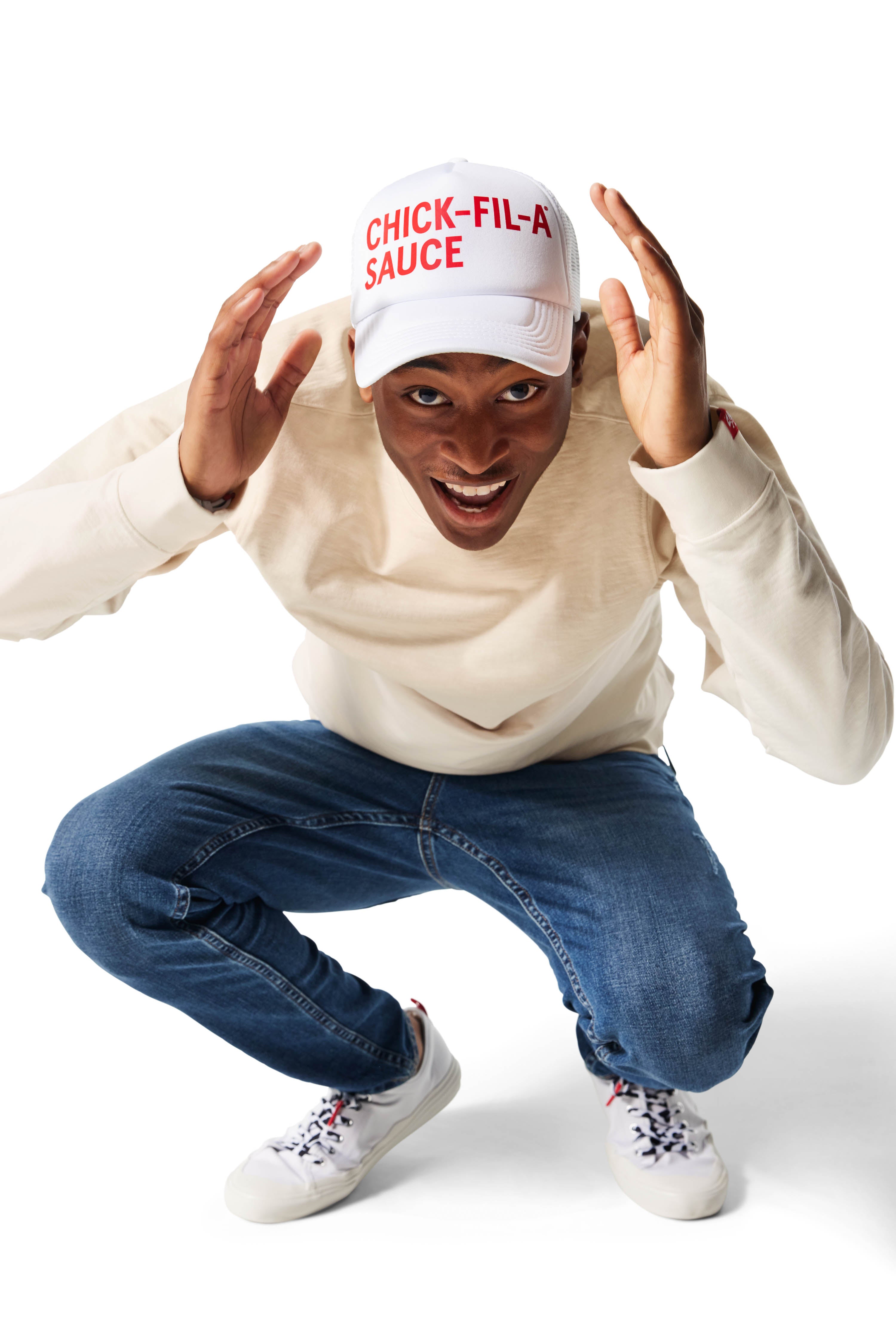 Man wearing white Trucker Hat with Chick-fil-A Sauce printed in red