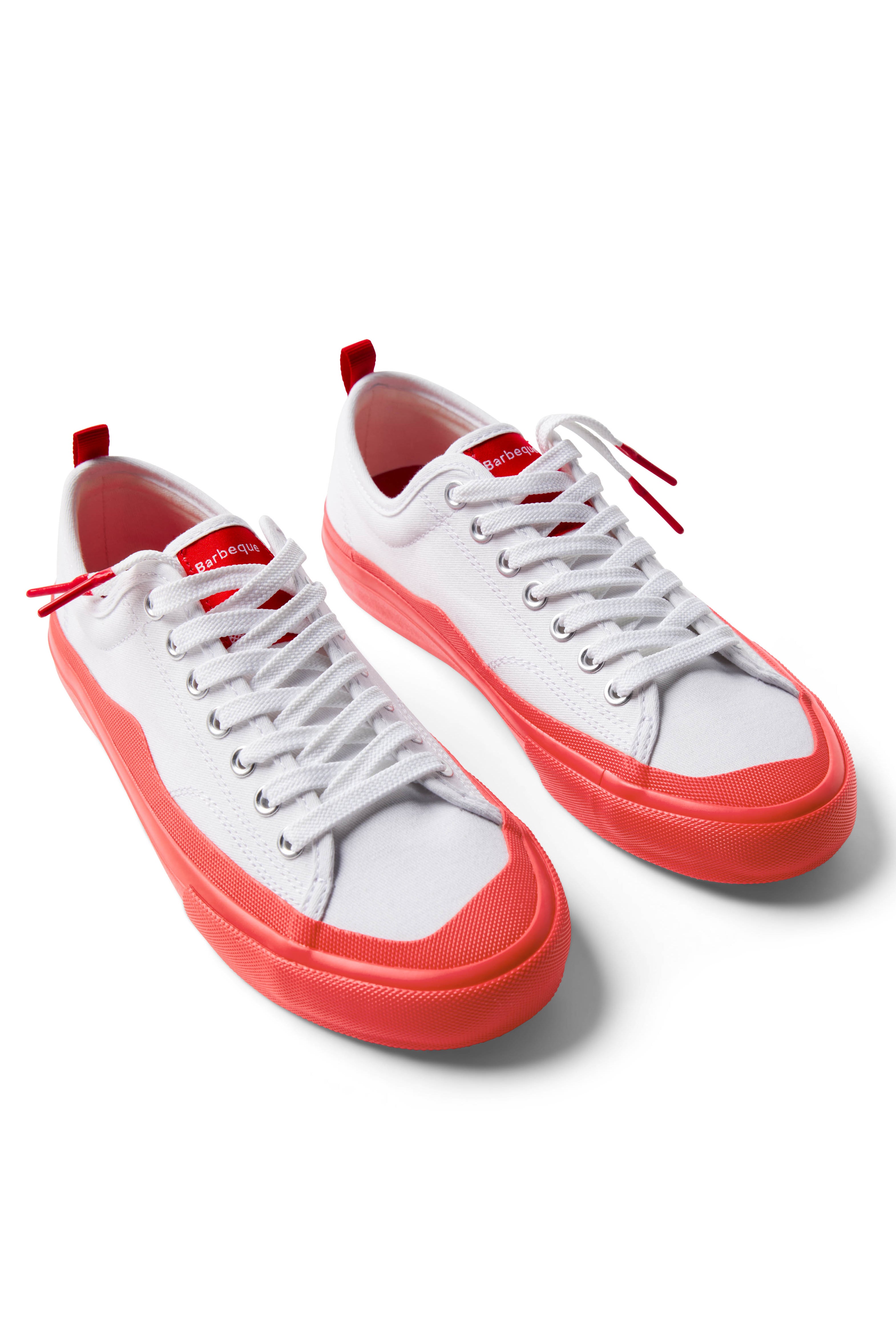 Pair of Dipped Kicks white shoes with red soles