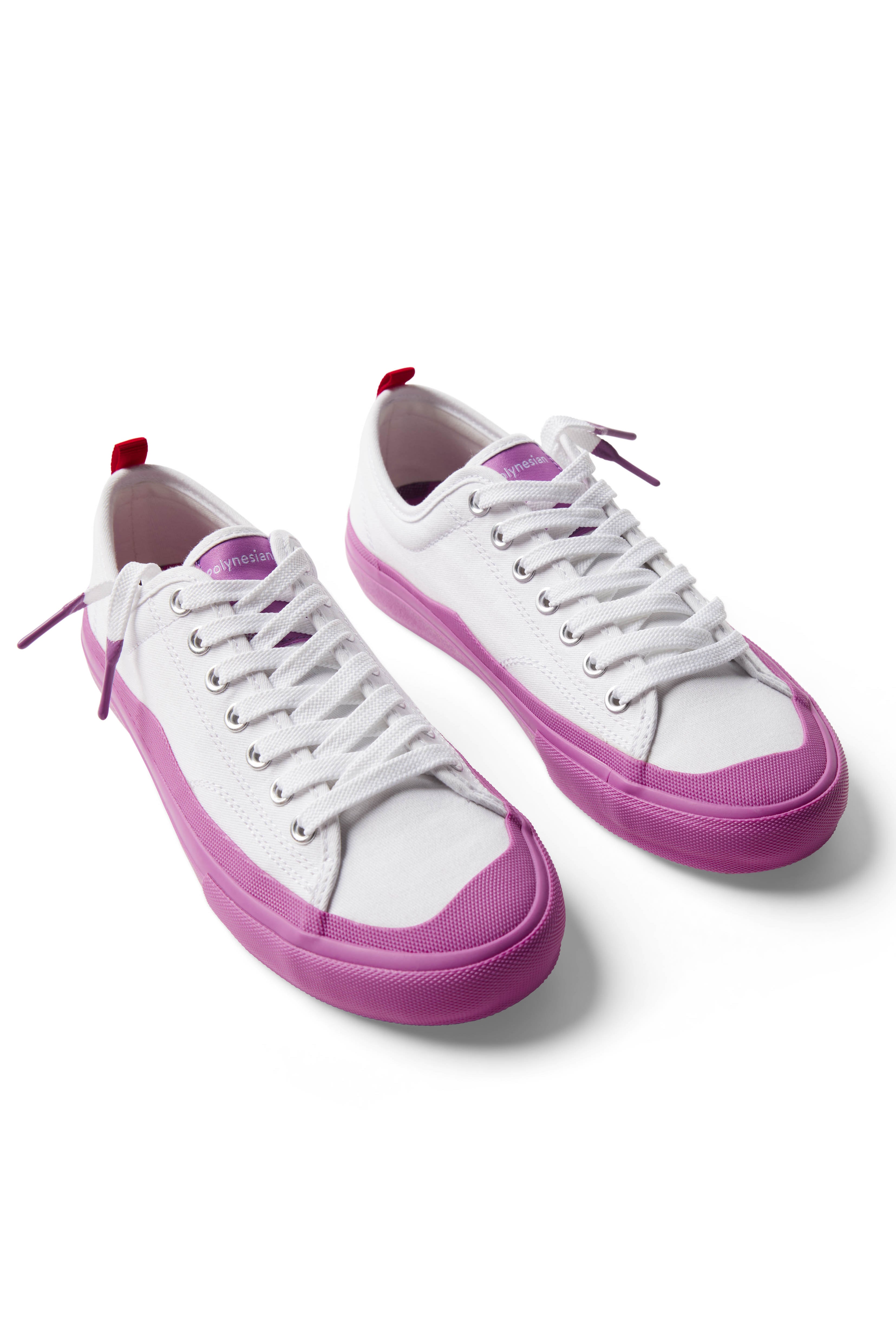 Pair of Dipped Kicks white shoes with purple soles