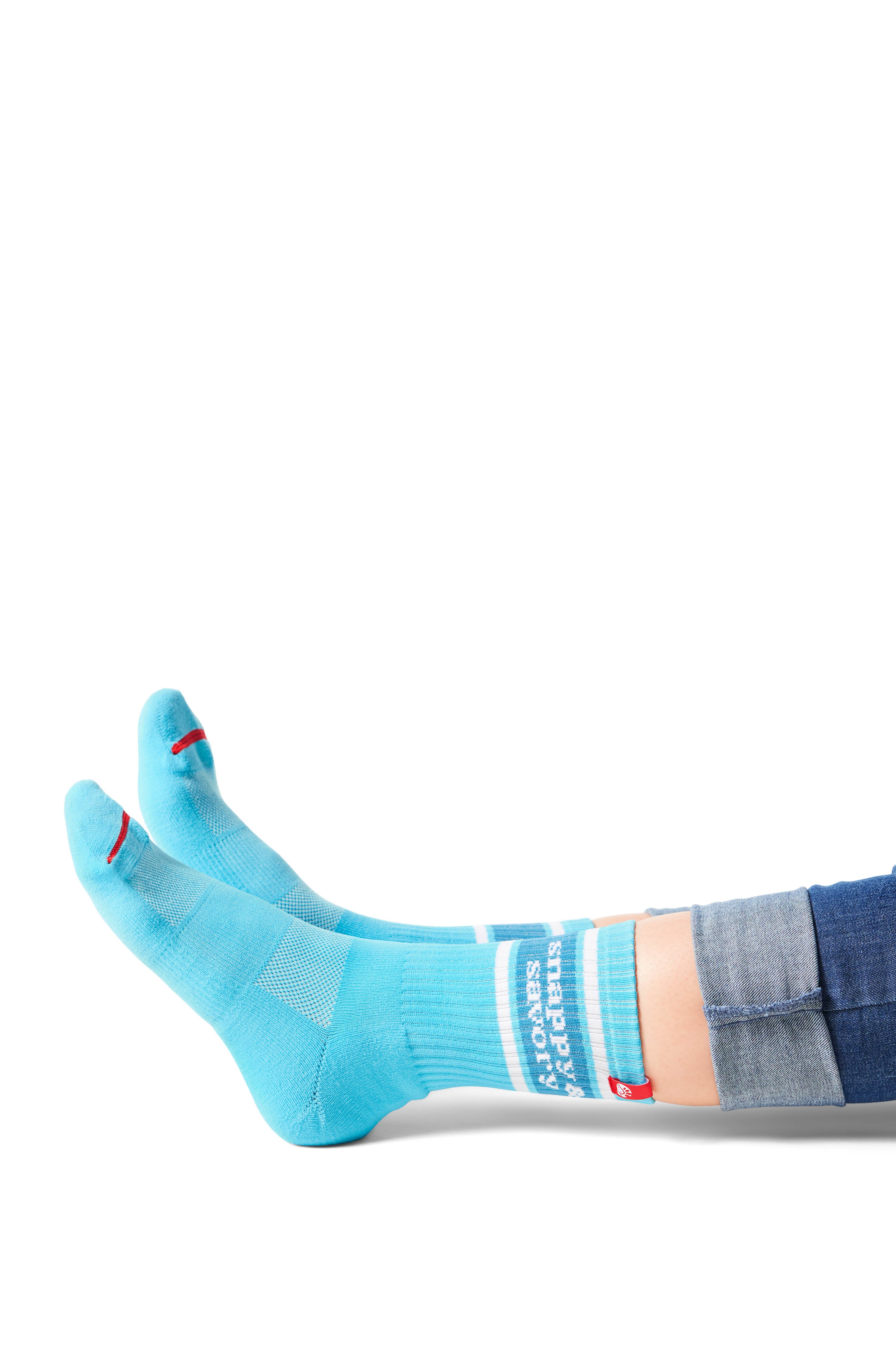 Pair of feet wearing blue socks with text &quot;snappy &amp; savory&quot; above ankle on sock