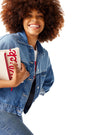 Closeup of woman in denim jacket and holding Classic Chick-fil-A™ Clutch