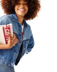 Closeup of woman in denim jacket and holding Classic Chick-fil-A™ Clutch