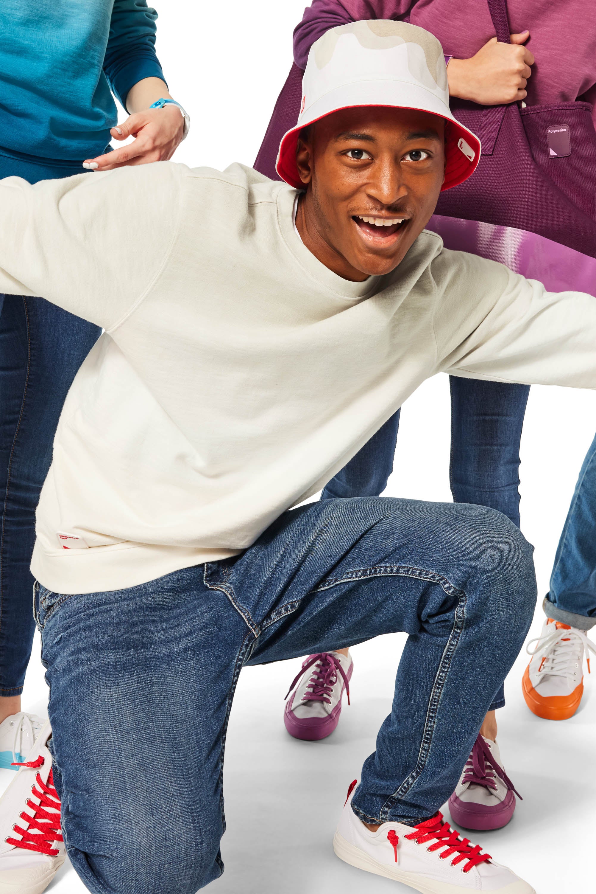 Man kneeling with arms out wearing Chick-fil-A Sauce Crewneck and Bucket Hat