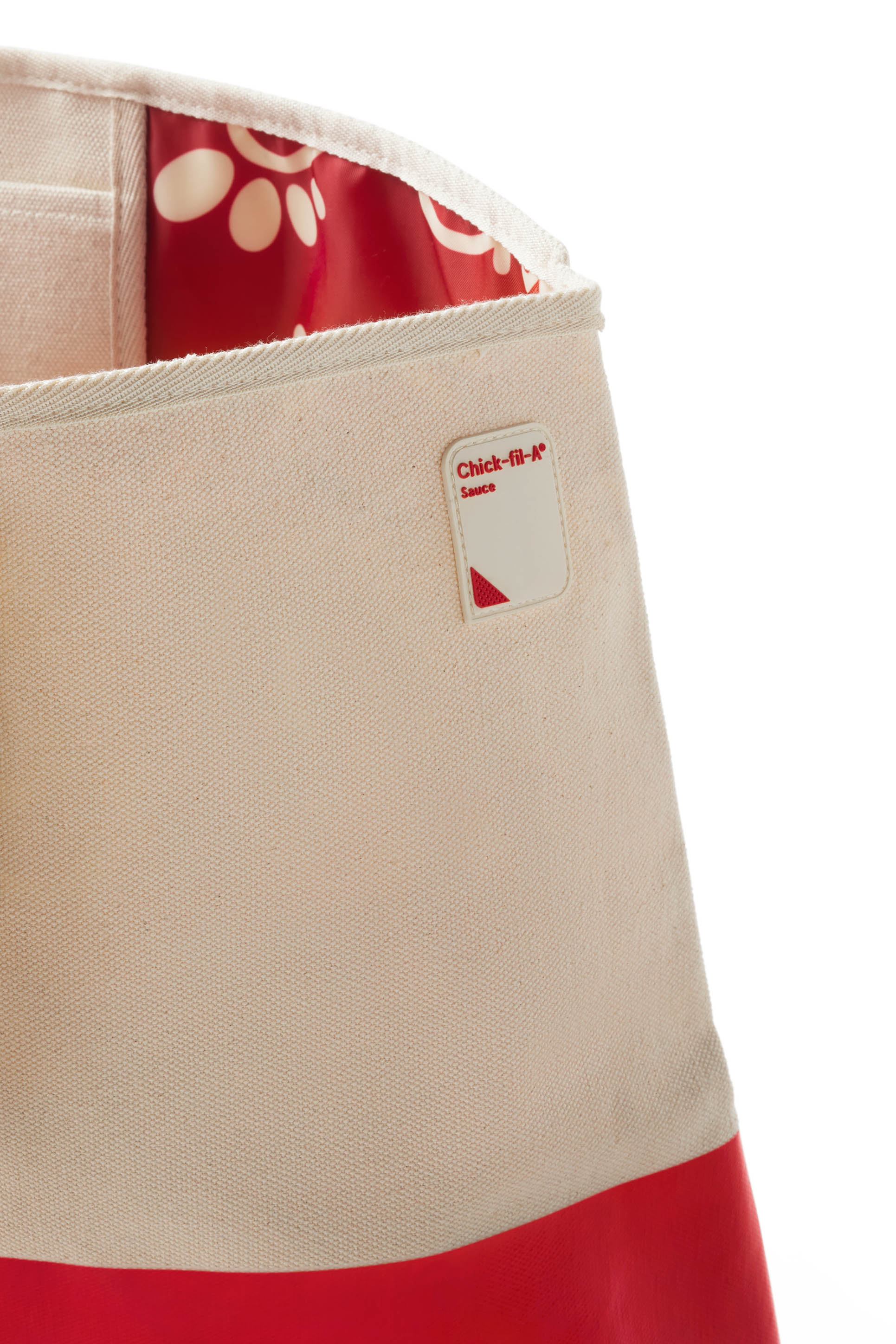 Closeup of silicone sauce patch on canvas and red Chick-fil-A Sauce Oversiized Tote Bag