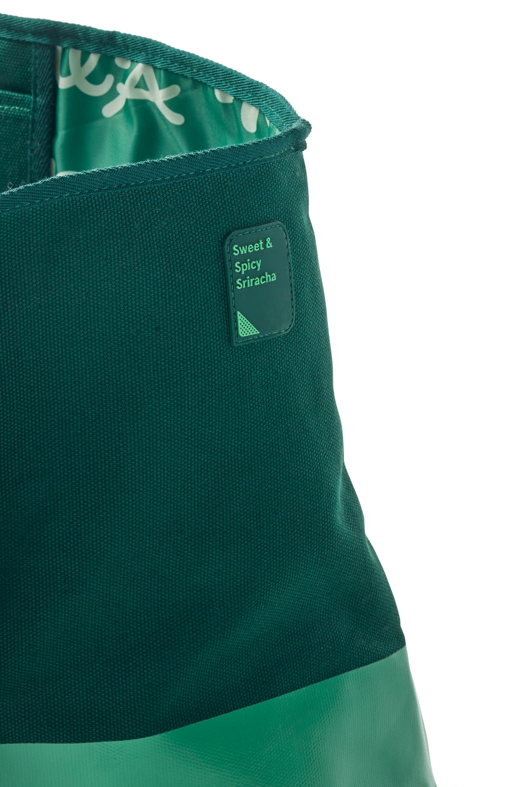 Closeup of silicone sauce patch on green Sweet &amp; Spicy Sriracha Sauce Oversiized Tote Bag