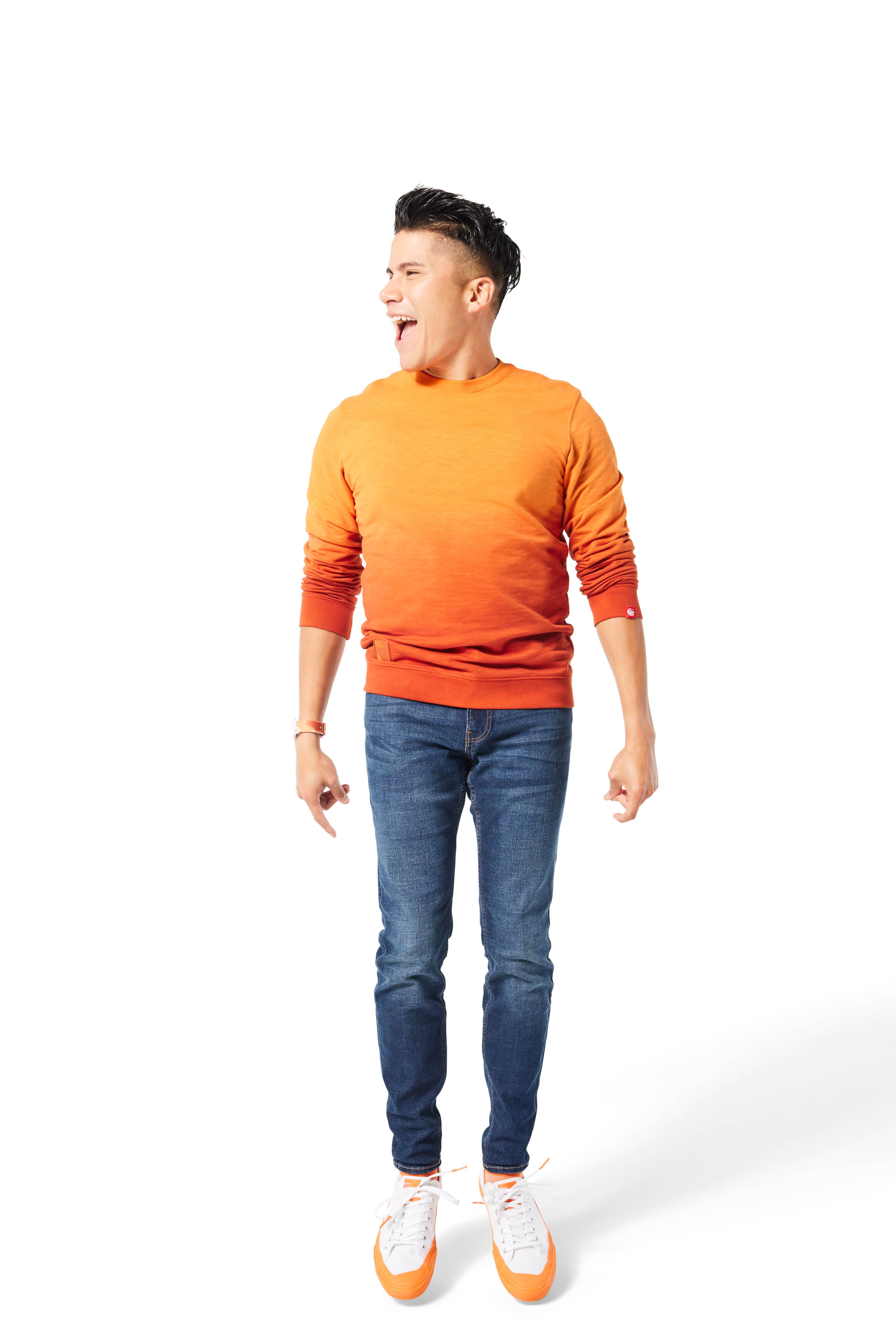 Man jumping in air wearing orange Ombre Crewneck with orange Dipped Kicks shoes