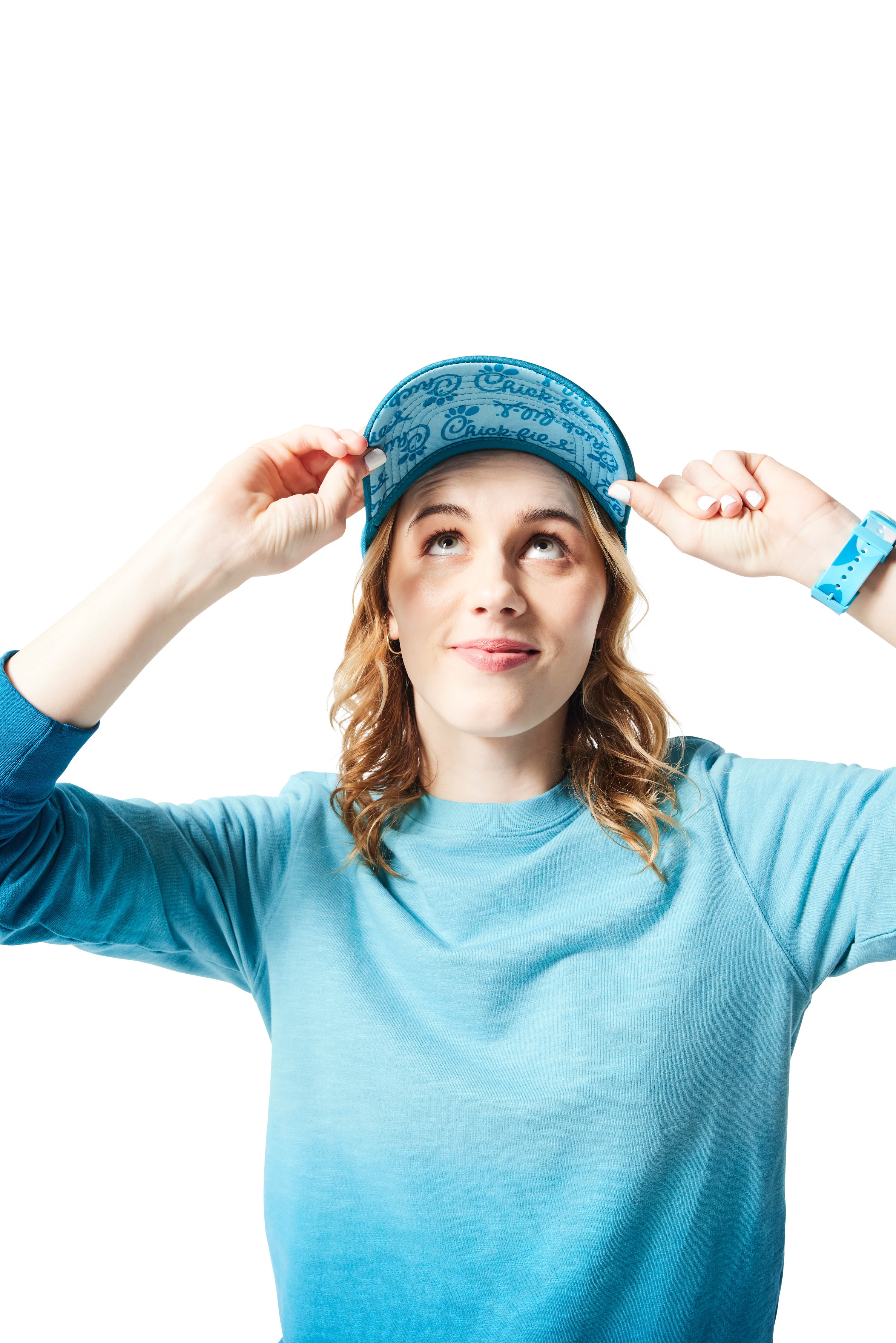 Blue Trucker Hat on woman with blonde hair holding hat and displaying tone-on-tone blue underbill