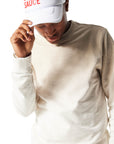 Closeup of man wearing white Trucker Hat with Chick-fil-A Sauce printed in red