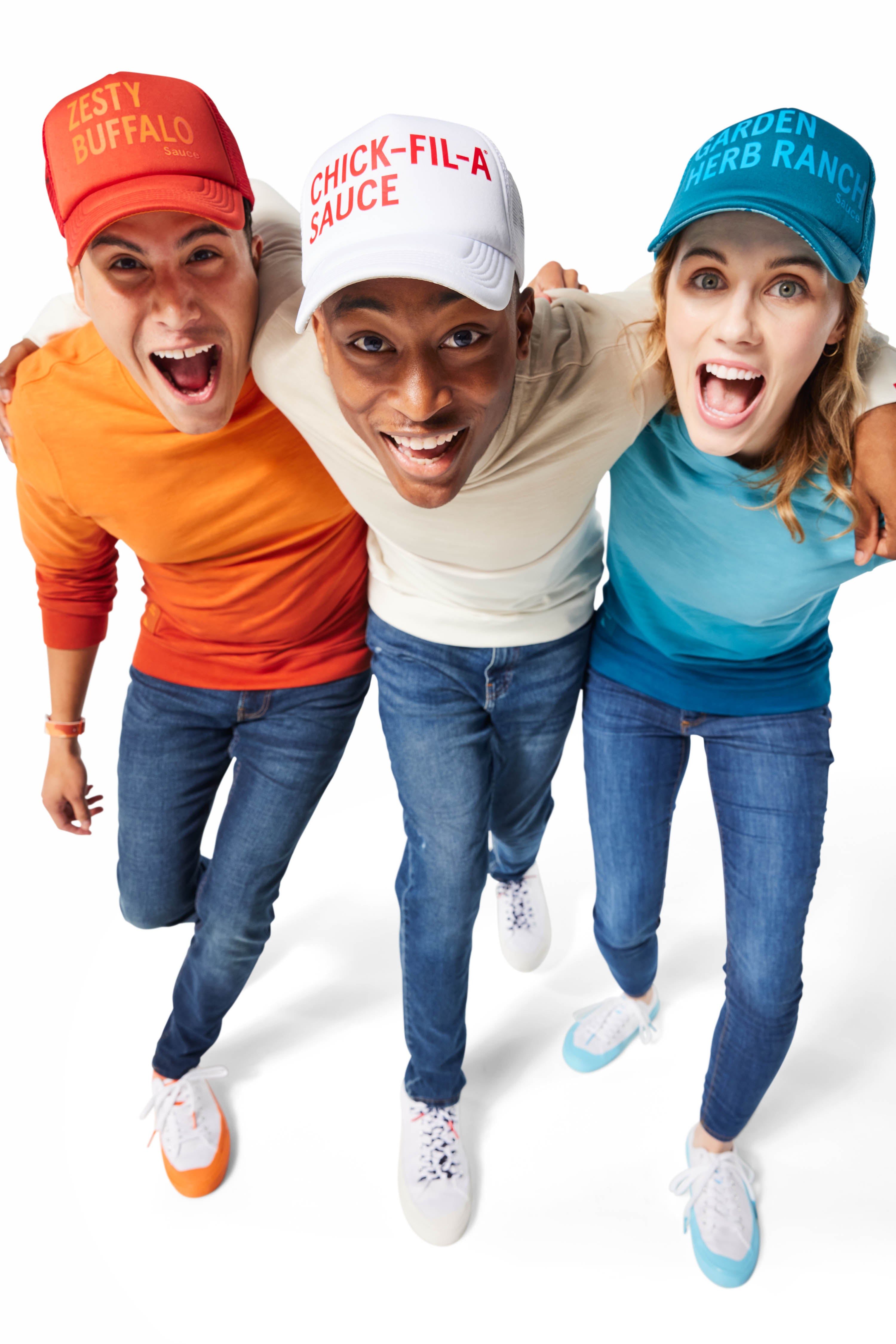 Group of 3 people wearing orange, white/gray, and blue Ombre Crewnecks and Trucker Hats