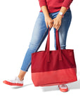 Woman holding red tone-on-tone Barbeque Oversized Tote Bag and wearing red Dipped Kicks