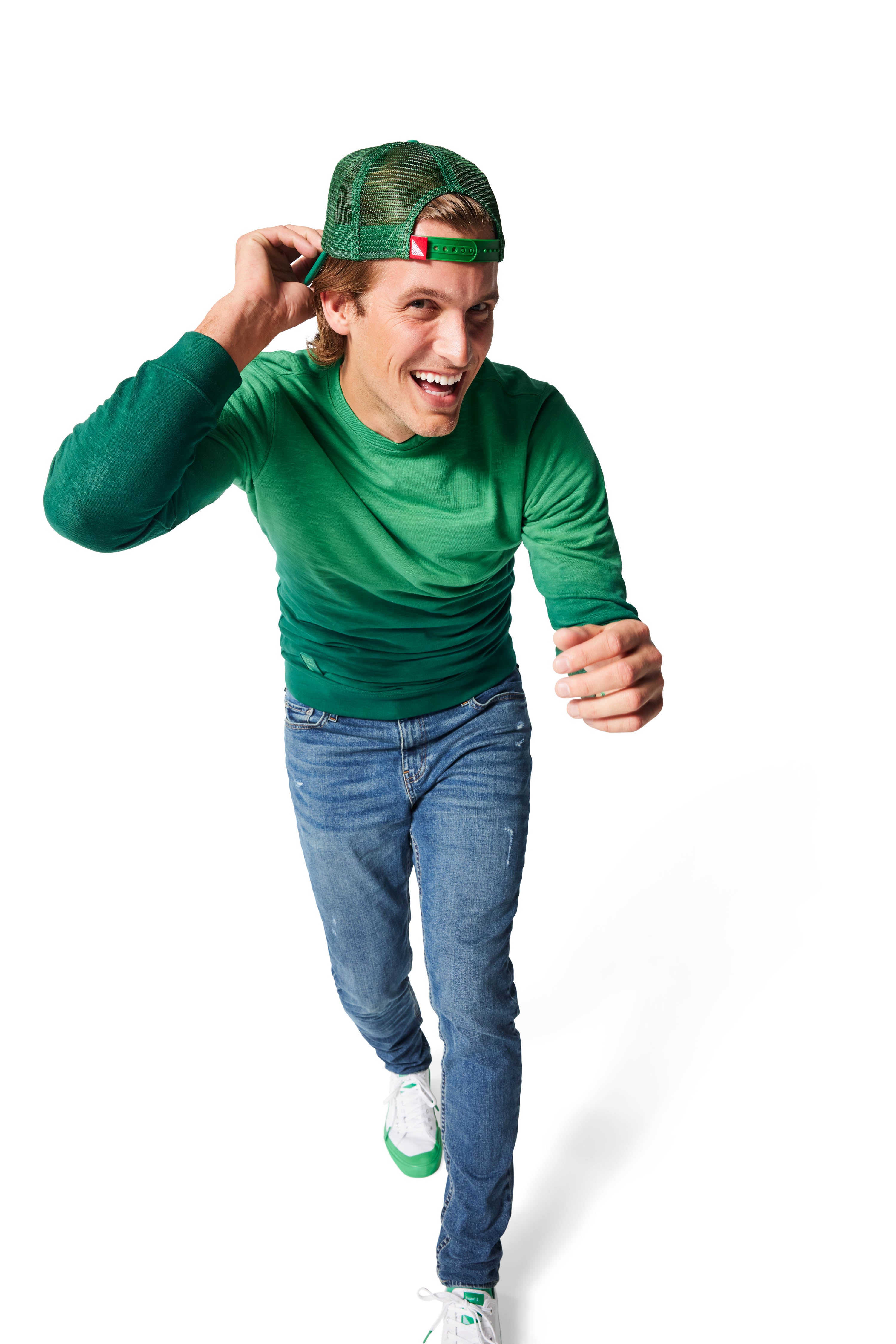 Man walking wearing green Ombre Crewneck with green Dipped Kicks shoes and green Trucker Hat