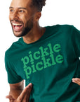 Man smiling and looking away from camera and showing off the Pickle Pickle Tee he is wearing