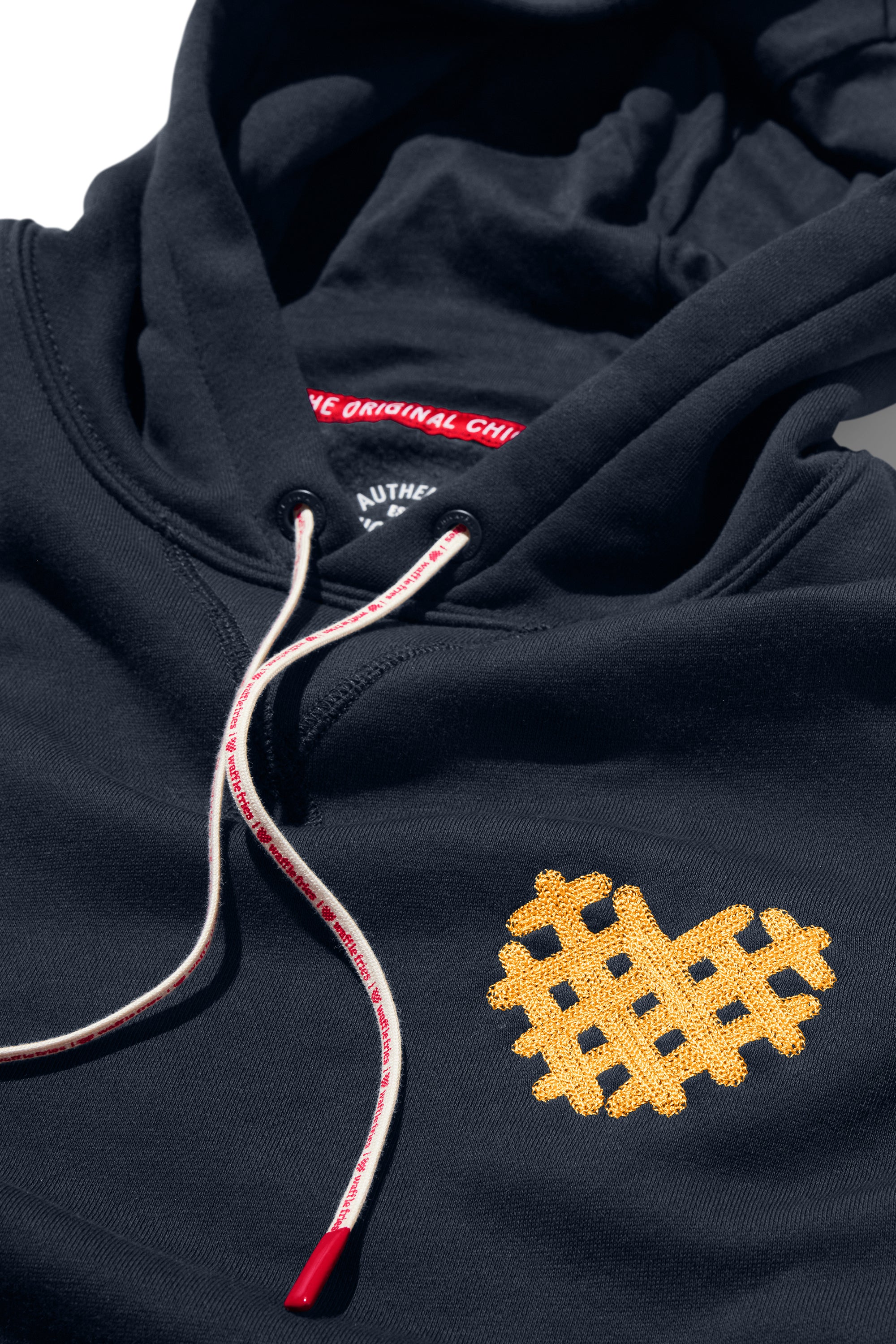 Closeup of heart-shaped Waffle Fry embroidery on I Heart Waffle Fries Hoodie