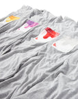 Gray Sauce Drip Pocket Tees laying in a row featuring yellow, purple, red, and gray pockets